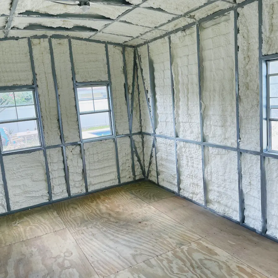Closed-cell spray foam insulation applied to wall cavities in a residential project in Upton